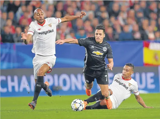  ?? Picture: Getty. ?? Steven N’Zonzi and Luis Muriel of Sevilla battle with Manchester United’s Alexis Sanchez in the Estadio Ramon Sanchez last night.