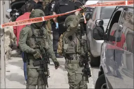  ?? MAHMOUD ILLEAN — THE ASSOCIATED PRESS ?? Israeli police secure a shooting attack site in east Jerusalem on Saturday.