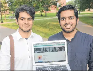  ?? MITCH MACDONALD/THE GUARDIAN ?? UPEI graduates Alkarim Bhalesha, left, and Vimal Ramaka show their new web app, “Bazr”, after launching the service earlier this week. The app aims to connect buyers and sellers of textbooks and is currently available for UPEI students. The two have...