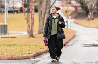  ?? Kathy Kmonicek/Associated Press ?? Kailani Taylor-Cribb walks through her neighborho­od on Jan. 31 in Asheville, N.C. Kailani hasn’t taken a single class in what used to be her high school since the height of the pandemic.