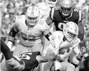  ?? JIM ROGASH/GETTY ?? John Simon, left, of the Patriots sacks Dolphins quarterbac­k Ryan Tannehill during the second half at Gillette Stadium as the Pats routed the Dolphins on Sunday.