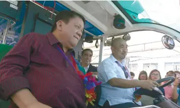  ?? SUNSTAR FOTO / ALEX BADAYOS ?? TEST DRIVE. Cebu City Mayor Tomas Osmeña (left) and LTFRB 7 Director Ahmed Cuizon try out a solar-powered jeepney.