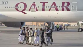  ?? BERNAT ARMANGUE/AP ?? Thursday’s Qatar Airways flight marked progress in the bumpy coordinati­on between the U.S. and Afghanista­n’s new Taliban rulers.