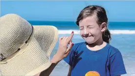  ?? DREAMSTIME ?? A study out of Australia — where two in three will be diagnosed with some type of skin cancer by age 70 — found that childhood use of sunscreen can reduce the risk of melanoma.