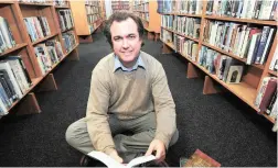  ?? PICTURE HENK KRUGER/ANA ?? AIMING HIGH: Shaun Jooste, owner of Celenic Earth Publicatio­ns, poses inside Parow Library with his record-setting anthology.