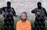  ?? AFP ?? This video image released on Tuesday shows Japanese national Yasuda Jumpei appealing for his release as two armed men stand behind him at an unknown location in Syria. —