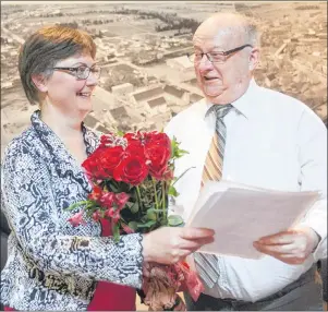  ?? MITCH MACDONALD/THE GUARDIAN ?? Montague Mayor Richard Collins presents budget director Jill Walsh with a bouquet of roses while she hands him the outline for the town’s 2018 general operating budget. Council voted unanimousl­y in favour of the budget, which saw no property tax...