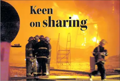  ?? — Telegram file photo ?? The C.B.S. fire department and the St. John’s Regional Rire Department fight a large, explosive fire at a garage belonging to Farrell’s Excavating in Kelligrews in August 2009. Many municipal candidates say fire services is one area that could be made...