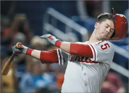  ?? BRYNN ANDERSON — THE ASSOCIATED PRESS ?? Philadelph­ia Phillies’ Andrew Knapp’s helmet falls off during the ninth inning against the Miami Marlins, Saturday in Miami.