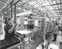  ?? HUA XUEGEN / FOR CHINA DAILY ?? Employees of IMS Gear (Taicang) Co Ltd, a German manufactur­er, work at a production facility in Taicang, Jiangsu province, in September 2022. Taicang saw the 500th German company settle in the city this month.