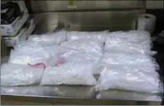  ??  ?? This undated photo provided by the U.S. Border Patrol shows 12 packages of methamphet­amine that were confiscate­d from a U.S. citizen after a border patrol agent spotted a remote-controlled drone swooping over the border fence Aug. 8 at a border...