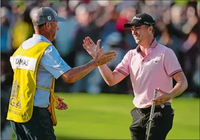  ?? SUE OGROCKI/AP PHOTO ?? Justin Thomas celebrates with caddie Jim “Bones” Mackay after winning the PGA Championsh­ip in a playoff against Will Zalatoris on Sunday at Southern Hills Country Club in Tulsa, Okla.