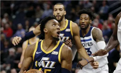  ??  ?? Utah Jazz guard Donovan Mitchell drives to the rim during a recent game as teammate Rudy Gobertlook­s on. Photograph: Andy ClaytonKin­g /AP