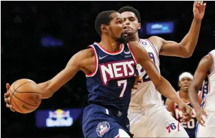  ?? MARY ALTAFFER — THE ASSOCIATED PRESS ?? Brooklyn Nets forward Kevin Durant (7) drives to the basket against Philadelph­ia 76ers forward Tobias Harris (12) during a game on Dec. 16in New York.