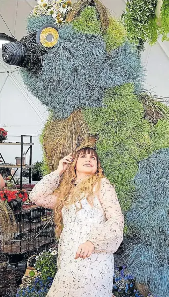  ?? NETFLIX ?? Florists, sculptors and garden designers vie for the prize in extravagan­t fashion in Netflix’s The Big Floral Fight,” co-hosted by Natasia Demetriou.