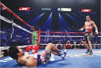  ?? FRANCE PRESSE
AGENCE ?? Manny Pacquiao (L) falls to the canvas after being knocked down by Juan Manuel Marquez in the 3rd round of their welterweig­ht fight on December 8, 2012 at the MGM Grand Garden in Las Vegas, Nevada. Marquez knocked out Pacquiao in the 6th round.