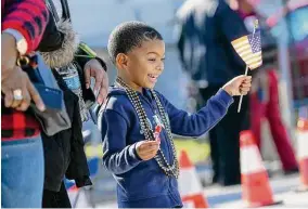  ?? Staff file photo ?? Jamal Ali, 4, waves a U.S. flag during the MLK Grande Parade last Jan. 17 in Houston. This year’s parade is set for Jan. 16.