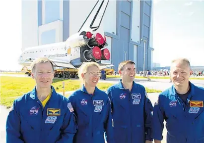  ?? ORLANDO SENTINEL FILE ?? Space shuttle Atlantis astronauts, from left, commander Chris Ferguson, Sandy Magnus, Rex Walheim and pilot Doug Hurley talk to the media on May 17, 2011, as their orbiter, background, is rolled to the Vehicle Assembly Building. Magnus and Ferguson recently were chosen, along with David Leestma, who oversaw dozens of shuttle flights, to join the U.S. Astronaut Hall of Fame. Their induction is set for June 11.