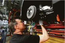  ?? Paul Sancya / Associated Press file ?? Wayne Peterson assembles a brake system at a Ford plant in Wayne, Mich. The nation added 313,000 jobs in February.