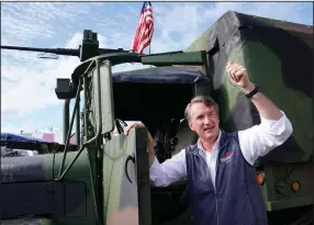  ?? (AP/Steve Helber) ?? Republican gubernator­ial candidate Glenn Youngkin gives a thumbs-up after getting out of an Army truck Saturday during an air show in Fredericks­burg, Va.