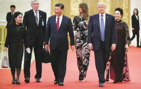  ?? Reuters ?? US President Donald Trump and First Lady Melania arrive for the state dinner with China’s President Xi Jinping and China’s First Lady Peng Liyuan at the Great Hall of the People in Beijing, China, yesterday