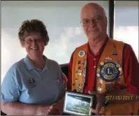  ?? Submitted photo ?? DECADE OF DEDICATION: Norine Westerbeck-Gillerman, director of the Seventh-Day Arkansas Camps for the Blind, left, presented a plaque to Hot Springs Village Breakfast Lions Club Past President Don Draper for his 10 years of volunteer service to the...