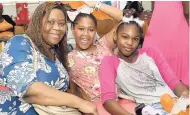  ??  ?? Tennesia Malcom (left) from The Gleaner, her daughter, Suri Ennis (centre), and friend Deniellia Grindley pose for the camera at the Faith United Church of God Internatio­nal 9th Annual Christmas Treat at 53 Mandela Terrace, Kingston 11, on Sunday, December 23.