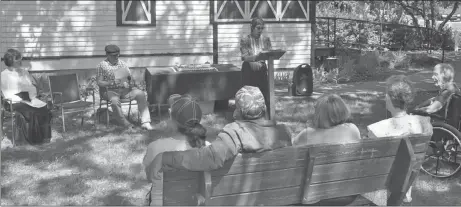  ?? Photos by Matthew Liebenberg ?? Beryl Robinson of Doc's Town speaks during the centennial celebratio­n. Seated behind her are Shelley Ferguson and Phil Hall, who participat­ed in the program to tell the story of siblings Andrew and Mary McLatchie.