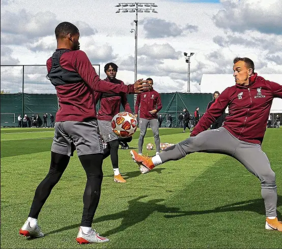  ??  ?? Stretching it: Xherdan Shaqiri beats Georginio Wijnaldum to the ball in training yesterday ahead of Liverpool’s battle to overturn a three-goal deficit against Barcelona