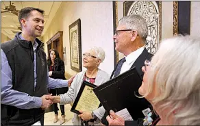  ?? Arkansas Democrat-Gazette/THOMAS METTHE ?? U.S. Sen. Tom Cotton congratula­tes the family of Bob Legan — Connie Wilson (center left), Ken Legan and Carol Erdmann — after a ceremony to honor their father Saturday during an American Legion conference in North Little Rock.