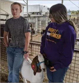  ?? JENNIE BLEVINS — ENTERPRISE-RECORD ?? Willows High School student Jose Fletes watches as student and Future Farmers of America adviser Kate Amaro keeps her goat in line at the Willows High School farm Thursday in Willows.