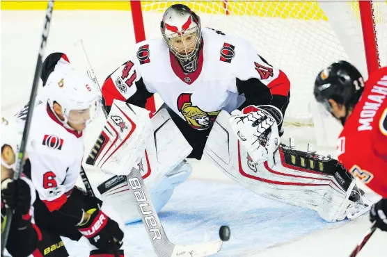  ?? AL CHAREST ?? Senators goalie Craig Anderson makes a save on Flames forward Sean Monahan Friday at the Saddledome as Ottawa blanked the hosts 6-0 thanks to the backstop’s 25-save effort.