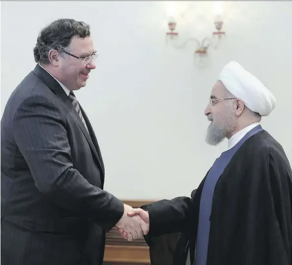  ?? IRANIAN PRESIDENCY OFFICE VIA AP ?? Iranian President Hassan Rouhani, right, welcomes Total CEO Patrick Pouyanne to their meeting in Tehran on Monday. Pouyanne says Iran and Total’s agreement to develop the South Pars offshore gas field heralds the “first of many” projects for Total in...