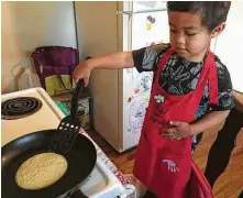  ?? Joey Guerra / Staff ?? Since the launch of stay-at-home orders earlier this year, many Houstonian­s have taken the opportunit­y to encourage their children to cook alongside adults.