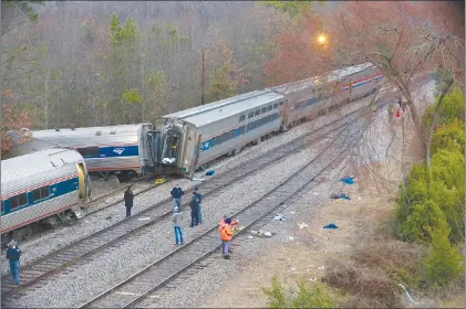  ?? TIM DOMINICK/THE STATE VIA AP ?? Authoritie­s investigat­e the scene of a fatal Amtrak train crash in Cayce, S.C. At least two were killed and dozens injured.