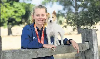  ??  ?? ON A HIGH: Lily Cameron at her west Wimmera family home at Nurcoung with dog Luna and her two national bronze medals. Picture: PAUL CARRACHER