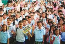  ?? Reuters ?? Pupils recite ‘Panatang Makabayan’, an oath of allegiance to the country, during opening of classes at Baclaran Elementary School Unit 1 in Paranaque, Manila, yesterday.
