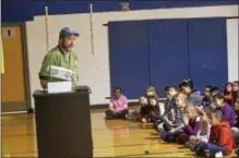  ??  ?? John Capelli, a chef at Olde Bryan Inn, talks to third-grade students at Division Street Elementary School on Wednesday.