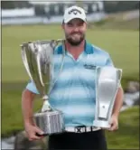  ?? CHARLES REX ARBOGAST — THE ASSOCIATED PRESS ?? Marc Leishman smiles as he poses with the Wadley Cup, left, and the BMW Championsh­ip trophy after winning the tournament last year at Conway Farms Golf Club in Lake Forest, Ill. Leishman will defend his BMW title when the tournament comes to Aronimink Golf Club in September.