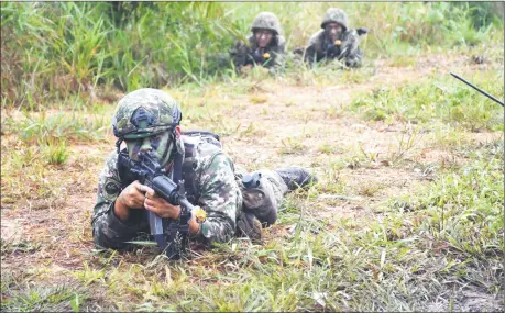  ?? — Photo courtesy of First Infantry Division ?? Members of the Third Infantry Brigade undergoing tactical training during the FTX in Lundu.