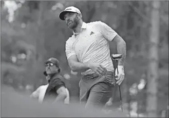  ?? ALASTAIR GRANT/AP PHOTO ?? Dustin Johnson of the United States watches the flight of his ball after playing off the 4th tee as Phil Mickelson of the United States looks on in the background during the first round of the inaugural LIV Golf Invitation­al on Thursday at the Centurion Club in St. Albans, England.