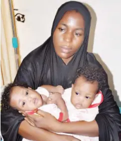  ??  ?? Mother of the twins Kellu Adam with her co-joined children before the surgery