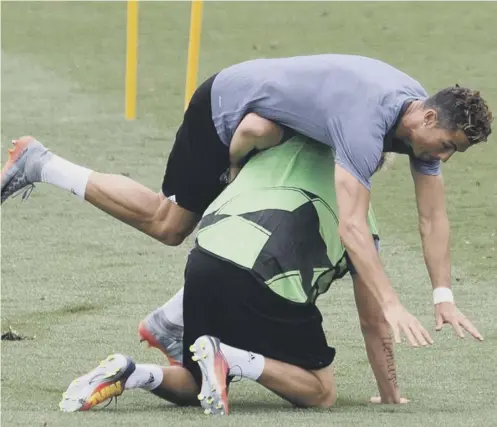  ??  ?? 0 Cristiano Ronaldo falls over his Real Madrid team- mate Fabio Coentrao during training before Saturday’s Champions League final.