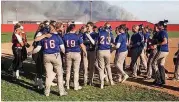  ?? [PHOTO PROVIDED] ?? The Vici and Waukomis softball teams gather after playing each other while smoke from nearby wildfires hovers nearby.