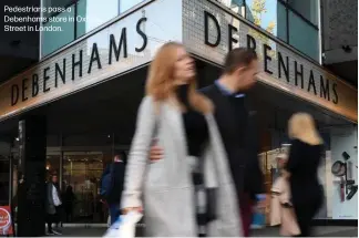  ??  ?? Pedestrian­s pass a Debenhams store in Oxford Street in London.