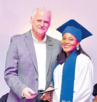  ?? ?? Gebhard Rainer, Chief Executive Officer, Sandals Resorts Internatio­nal presents Joy Bernhard, Learning and Developmen­t Manager at Sandals Ochi, with her diploma
