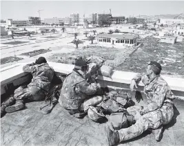  ?? OCCRP/Dino Fracchia / Alamy ?? An Italian military unit — part of a United Nations peacekeepi­ng mission to Albania — keeps watch over Vlora in 1997.