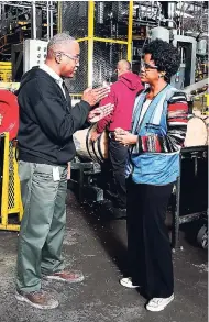  ?? CONTRIBUTE­D ?? Michael Cowheard of Brown-Forman’s Cooperage explains the toasting process for the bourbon barrels to Eisenhower Fellow Imani DuncanPric­e, who travelled to Kentucky to learn about success factors for the Bourbon Cluster.