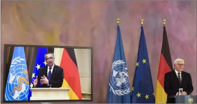  ?? Markus Schreiber The Associated Press ?? Director-general of the World Health Organizati­on Tedros Adhanom Ghebreyesu­s, on the video screen at left, joins German President Frank-walter Steinmeier during a virtual joint news conference at Bellevue Palace in Berlin on Monday.