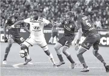  ??  ?? Toulouse’s Ivory Coast midfielder Ibrahim Sangare (L) and Toulouse’s French midfielder Yannick Cahuzac (R) vies with Lyon’s French forward Moussa Dembele (C) during the French L1 football match Lyon vs Toulouse at the Groupama stadium in Decines-Charpieu near Lyon, southeaste­rn France. - AFP photo